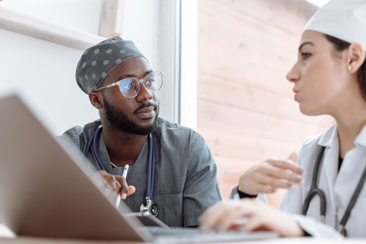 Two healthcare professionals coordinating their work